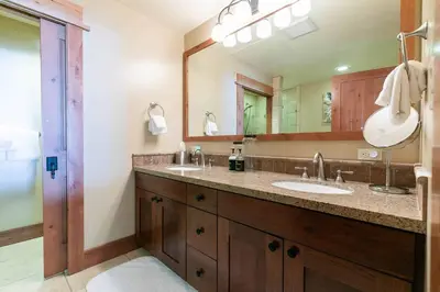 a bathroom with two sinks and a large mirror at Big Horn Lodge 206 by East West in Truckee