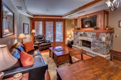 a living room with a couch and a fireplace at Big Horn Lodge 309 by East West Hospitality in Truckee
