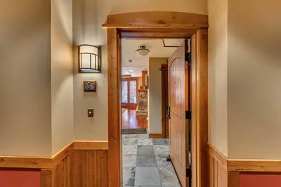 a hallway of a home with a wooden door at Big Horn Lodge 309 by East West Hospitality in Truckee