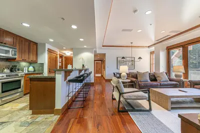 a kitchen and living room with a couch and a table at Big Horn Lodge 404 by East West Hospitality in Truckee