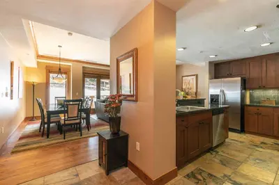 a kitchen and dining room with a dining table at Big Horn Lodge 310 by East West Hospitality in Truckee