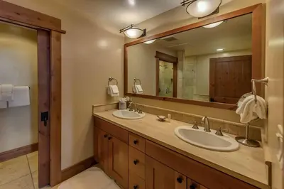 a bathroom with two sinks and a large mirror at Big Horn Lodge 403 by East West Hospitality in Truckee