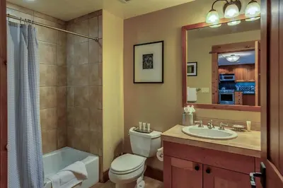 a bathroom with a toilet and a sink and a shower at Big Horn Lodge 403 by East West Hospitality in Truckee