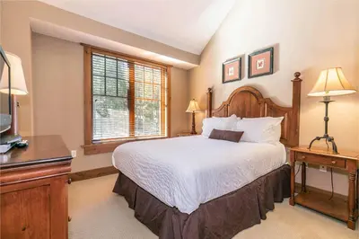a bedroom with a large bed and a window at Big Horn Lodge 510 by East West Hospitality in Truckee