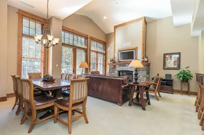 a dining room with a table and a couch at Big Horn Lodge 510 by East West Hospitality in Truckee