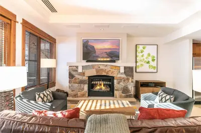 a living room with a couch and a fireplace at Big Horn Lodge 410 by East West Hospitality in Truckee