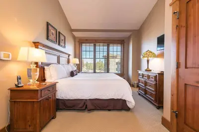 a bedroom with a large bed and a window at Big Horn Lodge 511 by East West Hospitality in Truckee