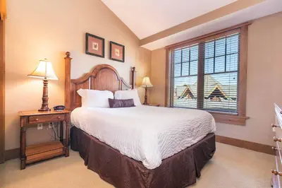 a bedroom with a large bed and a window at Big Horn Lodge 511 by East West Hospitality in Truckee