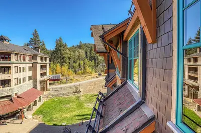 a view from the balcony of a house with an open window at Big Horn Lodge 511 by East West Hospitality in Truckee