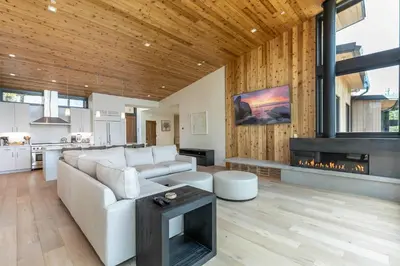 a living room with a white couch and a fireplace at Boulders 15136 by East West Hospitality in Truckee
