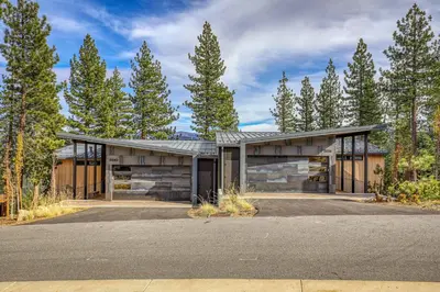 a house in the middle of a forest at Boulders 15136 by East West Hospitality in Truckee