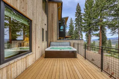 a deck with a hot tub and a hot tub at Boulders 15136 by East West Hospitality in Truckee