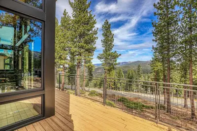 a balcony with a view of the mountains at Boulders 15136 by East West Hospitality in Truckee
