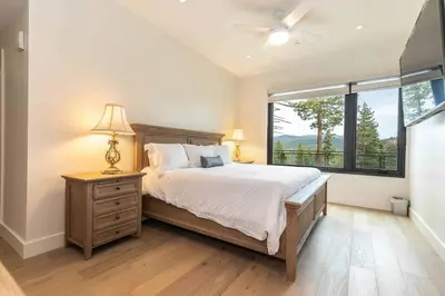 a bedroom with a large bed and a window at Boulders 15136 by East West Hospitality in Truckee