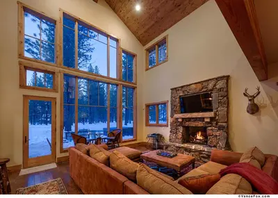 a living room with a couch and a fireplace at Caleb Drive 12802 by East West Hospitality in Truckee