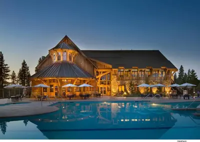 a large building with a pool in front of it at Caleb Drive 12802 by East West Hospitality in Truckee