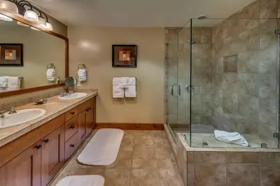 a bathroom with a shower and a sink at Catamount Lodge 103A by East West Hospitality in Truckee