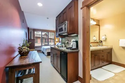 a kitchen with a sink and a microwave at Catamount Lodge 201A by East West Hospitality in Truckee