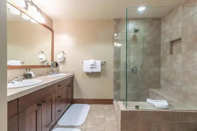 a bathroom with a shower and a sink at Catamount Lodge 201A by East West Hospitality in Truckee