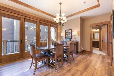 a dining room with a table and chairs at Catamount Lodge 308 by East West Hospitality in Truckee