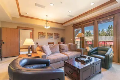 a living room with a couch and a table at Catamount Lodge 301 by East West Hospitality in Truckee