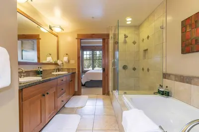 a bathroom with a tub and a sink and a shower at Catamount Lodge 401 by East West Hospitality in Truckee