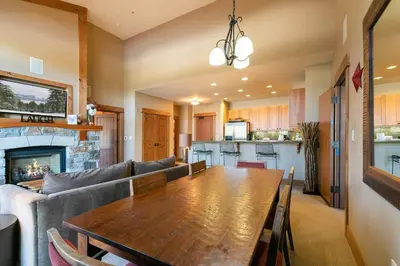 a living room with a table and a couch at Catamount Lodge 401 by East West Hospitality in Truckee
