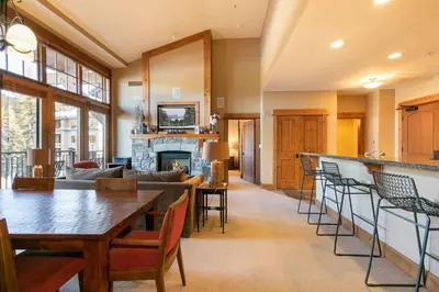 a living room with a couch and a fireplace at Catamount Lodge 401B by East West Hospitality in Truckee