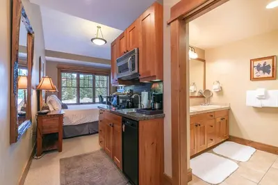 a kitchen with a sink and a microwave at Catamount Lodge 401A by East West Hospitality in Truckee