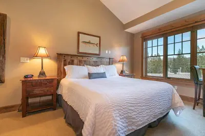 a bedroom with a large bed and a window at Catamount Lodge 401A by East West Hospitality in Truckee