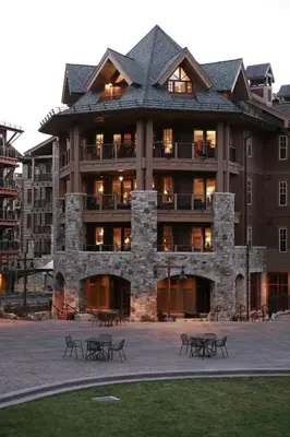 a large building with tables in front of it at Catamount Lodge 401A by East West Hospitality in Truckee
