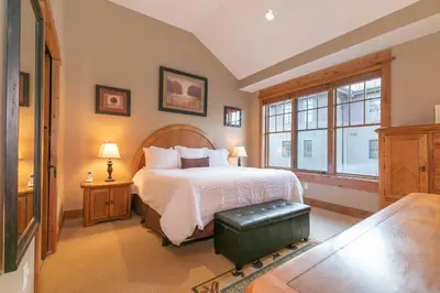 a bedroom with a large bed and a window at Catamount Lodge 404 by East West Hospitality in Truckee