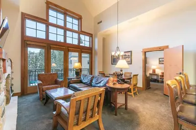 a living room with a couch and a table at Catamount Lodge 405 by East West Hospitality in Truckee