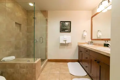 a bathroom with a shower and a sink at Catamount Lodge 405A by East West Hospitality in Truckee