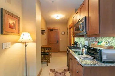 a kitchen with a sink and a microwave at Catamount Lodge 404A by East West Hospitality in Truckee