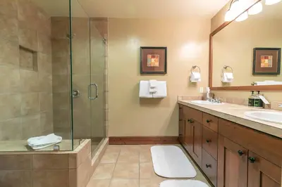 a bathroom with a shower and a sink at Catamount Lodge 404A by East West Hospitality in Truckee