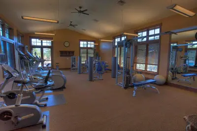 a gym with several treadmills and exercise bikes at Catamount Lodge 404A by East West Hospitality in Truckee