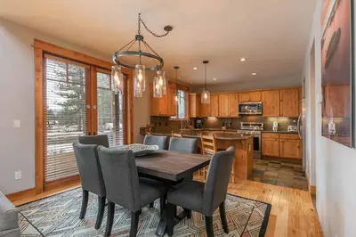 a kitchen and dining room with a table and chairs at Fairway Drive 13113 by East West Hospitality in Truckee