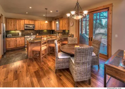 a kitchen with a table and chairs and a dining room at Fairway Drive 13136 by East West Hospitality in Truckee