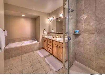 a bathroom with a tub and a sink and a shower at Fairway Drive 13136 by East West Hospitality in Truckee