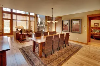a dining room and living room with a table and chairs at Gold Rush Trail 12560 by East West Hospitality in Truckee