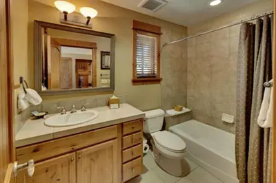 a bathroom with a sink and a toilet and a bath tub at Gold Rush Trail 12560 by East West Hospitality in Truckee