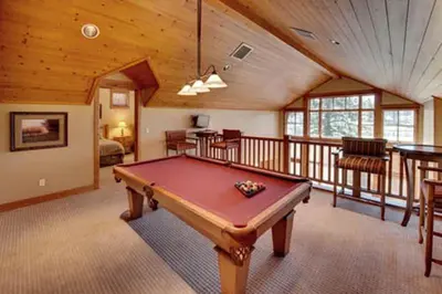 a room with a pool table in a house at Gold Rush Trail 12560 by East West Hospitality in Truckee