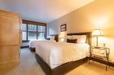 a bedroom with two beds and a window at Great Bear Lodge 201 by East West Hospitality in Truckee