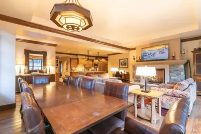a large living room with a wooden table and couch at Great Bear Lodge 201 by East West Hospitality in Truckee
