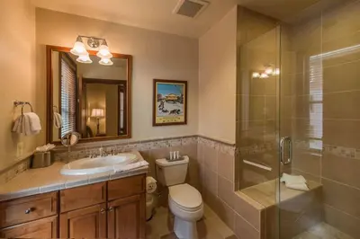 a bathroom with a toilet and a sink and a shower at Great Bear Lodge 306 by East West Hospitality in Truckee