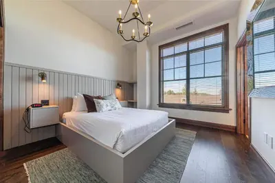 a bedroom with a large bed and a window at Great Bear Lodge 501 by East West Hospitality in Truckee