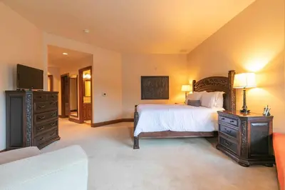a bedroom with a large bed and a television at Great Bear Lodge 302 by East West Hospitality in Truckee