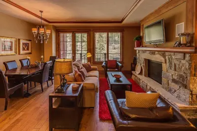 a living room with a couch and a fireplace at Iron Horse Lodge South 406 by East West Hospitality in Truckee