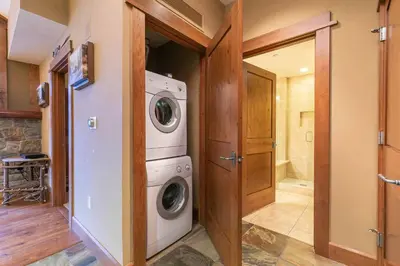 a laundry room with a washer and dryer at Iron Horse Lodge North 310 by East West Hospitality in Truckee